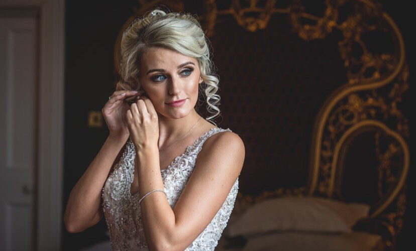 Bridal makeup shoot - bride adjusting an earring